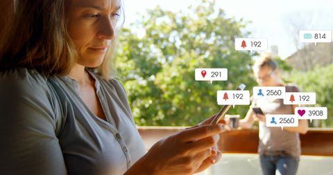 Woman Engaging with Social Media Icons on Smartphone at Home