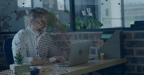 Businessman Focusing on Laptop Work in Modern Office