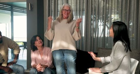 Senior woman speaking in group therapy session for communication