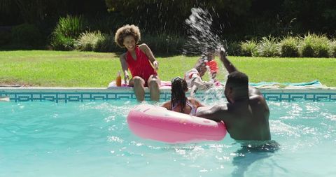 Joyful Family Enjoying Poolside Fun in Summer Sun