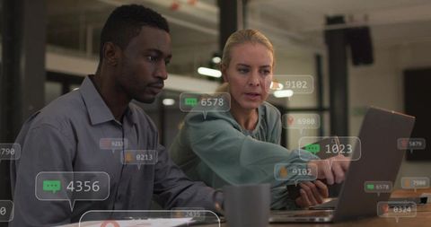 Collaborating on analytics dashboard, woman pointing at laptop, man analyzing data