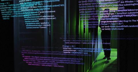 IT Technician Inspecting Server Racks in Dark Data Center with Green LED Backlighting