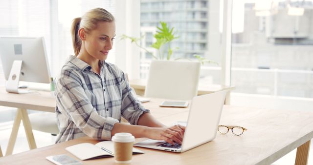 Young Professional Woman Working on Laptop in Bright Modern Office - Download Free Stock Images Pikwizard.com