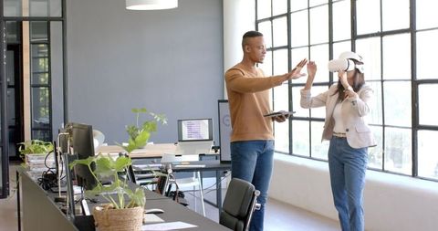 Business Team Engaging in Virtual Reality Collaboration in Modern Office