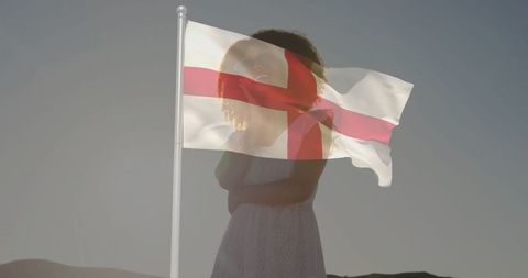 Young Woman Silhouette with St George's Cross Against Dawn Sky