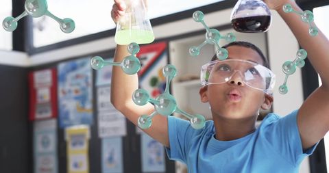 Child engaging in exciting chemistry experiment with beakers