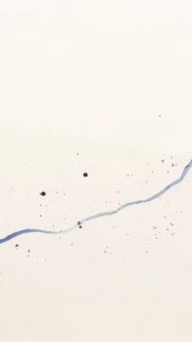 Vertical Video Moving Blue Ink Stroke Across Cream Paper with Droplets and Splatter Texture