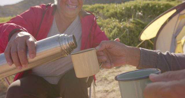 Senior campers enjoying hot beverages outdoors by a tent - Download Free Stock Images Pikwizard.com