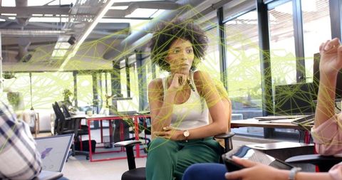 Thinking woman participating in augmented reality brainstorming session in modern office