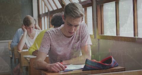 Teenage Boy Studying with Digital Financial Data Overlay - Download Free Stock Images Pikwizard.com