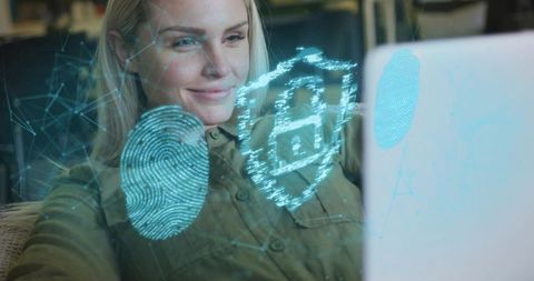 Woman engaging with digital security holograms on laptop