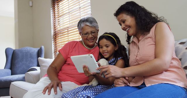 Three Generations of Women Enjoying Family Time with Tablet on Couch - Download Free Stock Images Pikwizard.com