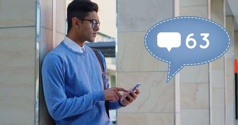 Young Man Focused on Smartphone with Notification Bubble