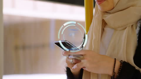 Muslim Woman Engaged with Smartphone and Digital Interface