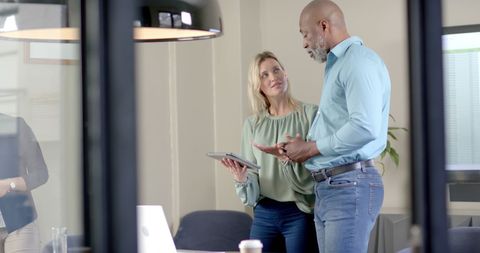 Caucasian Businesswoman Discussing with Colleague at Work