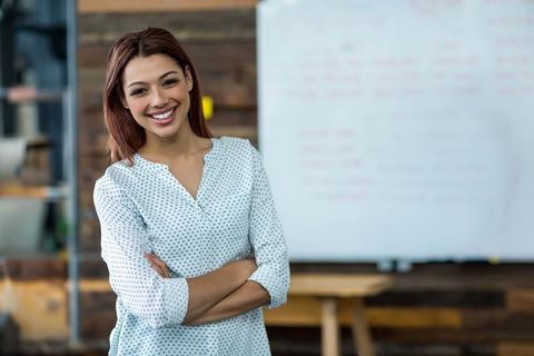 Confident Young Woman Leading Presentation in Modern Office