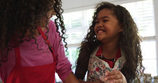 Mother and daughter bonding in kitchen with baking activity - Download Free Stock Images Pikwizard.com