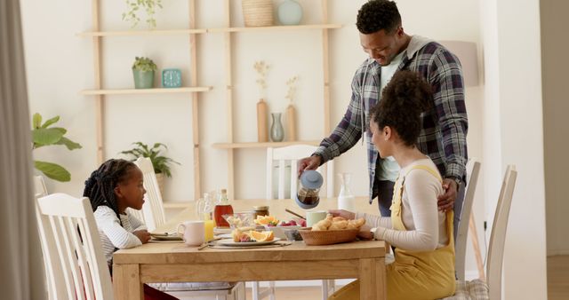 Happy Family Enjoying Breakfast Together at Home Dining Table - Download Free Stock Images Pikwizard.com