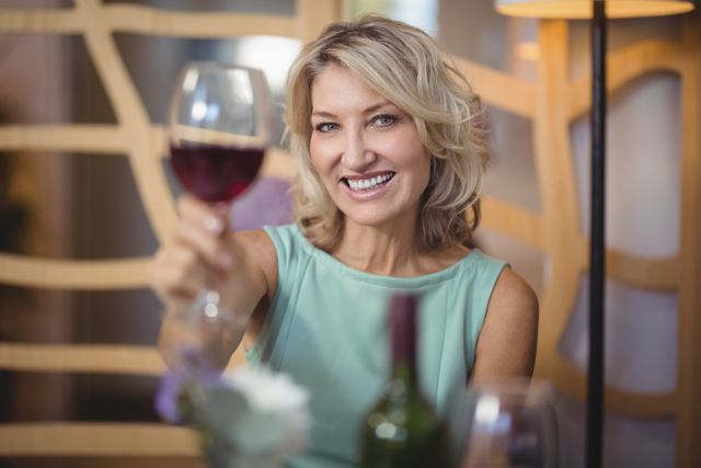 Portrait of mature woman holding a wine glass in restaurant