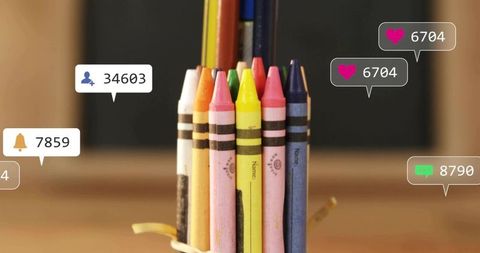 Vibrant wax crayons and pencils standing with social media notification icons