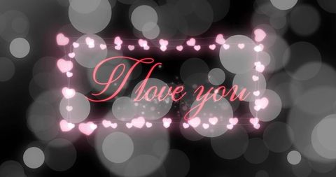 Romantic pink neon heart frame cursive i love you text on dark bokeh glow background