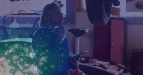 Car Technician Assessing Wheel in Auto Garage