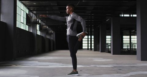 Athletic Man Stretching in Urban Industrial Space - Download Free Stock Images Pikwizard.com