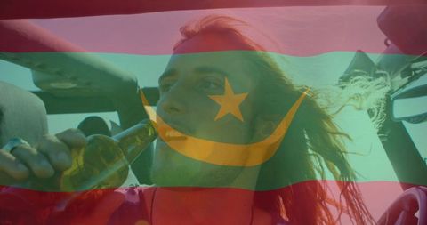 Young man enjoys road trip with bottle in hand, fun adventure outdoors