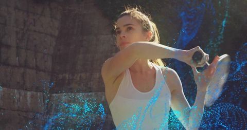 Sunlit Female Tennis Player Swinging Forehand with Blue Motion Trails and Rimlight