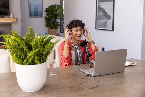 Content creator adjusting microphone in stylish home studio