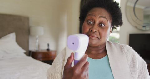 Senior woman shocked by thermometer at home