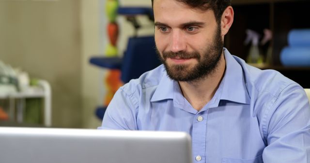 Bearded Man Working on Laptop in Modern Office - Download Free Stock Images Pikwizard.com