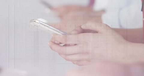 Hands holding smartphone in medical clinic typing message for telemedicine communication