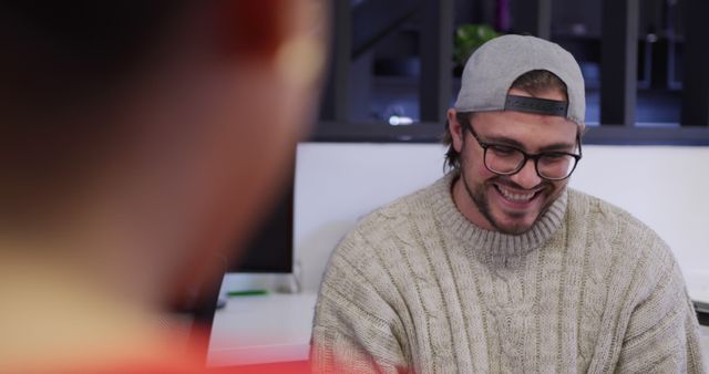 Smiling Man in Casual Wear and Baseball Cap in Office Space - Download Free Stock Images Pikwizard.com