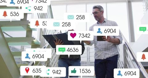 Business professionals walking stairwell with social media notification overlays and tablet