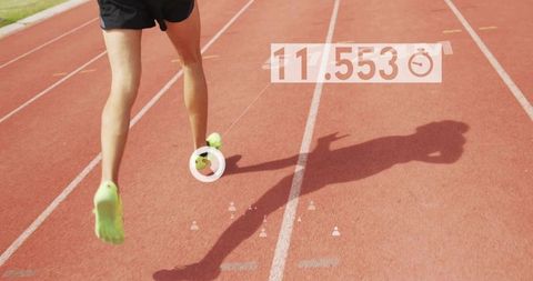 Sprinter sprinting on red track wearing neon green shoes hud timing overlay 11.553 seconds