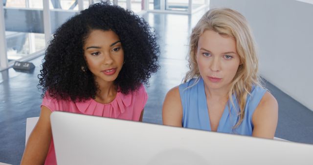 Two Women Collaborating on Computer in Modern Office Setting - Download Free Stock Images Pikwizard.com