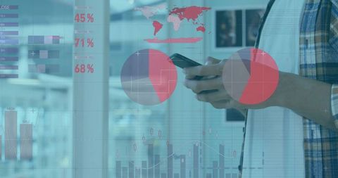 Man Holding Smartphone and Checking Financial Data Overlays with Charts and World Map