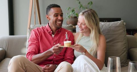 Interracial Couple Celebrating with Cake at Home