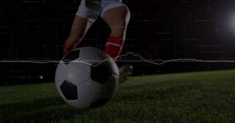 Dynamic Shot of Soccer Ball Kicked Under Stadium Lights