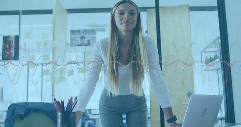 Sound waves overlaying woman in a contemporary office set-up