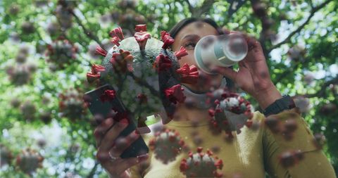 Woman in Park Using Smartphone with COVID-19 Cell Visualization