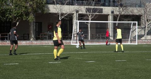 Youth Soccer Team in Action Near School Athletic Field