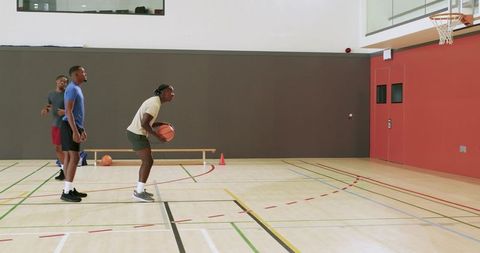 African american men practicing free throw shooting in indoor basketball gym training