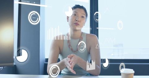 Asian Businesswoman Analyzing Data in Modern Office