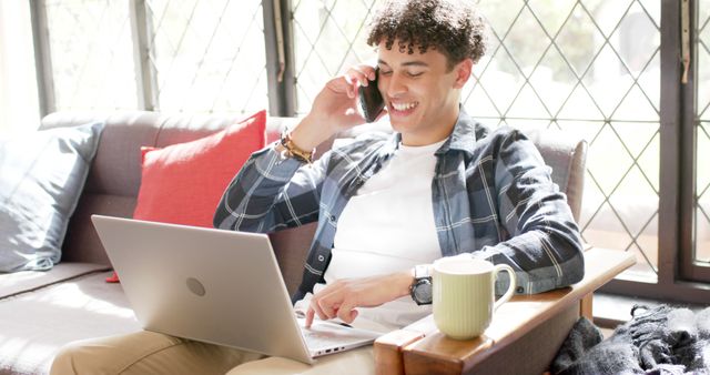 Smiling Man Talking on Phone While Working From Home with Laptop - Download Free Stock Images Pikwizard.com