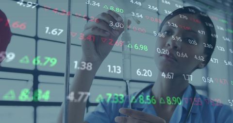 Nurse checking iv drip amid financial data screen