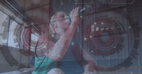 Woman in Green Tank Top Hydrating with Futuristic HUD Graphics