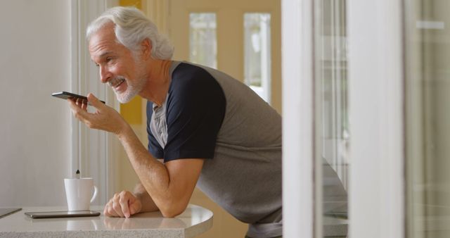 Senior Man Using Smartphone Voice Command in Modern Kitchen - Download Free Stock Images Pikwizard.com