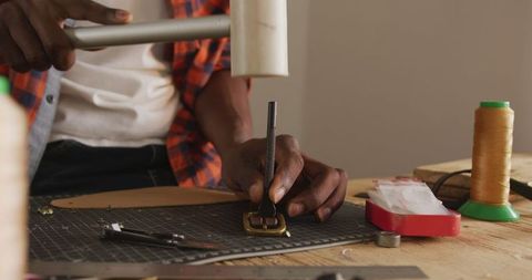 African American Craftsman Working on Leather Belt in Workshop